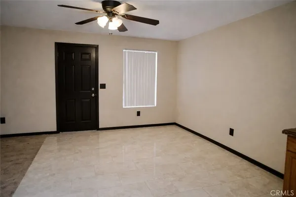 an empty room with windows and closet