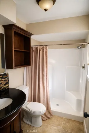 a bathroom with a sink toilet and mirror