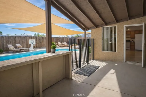 a view of a patio with table and chairs