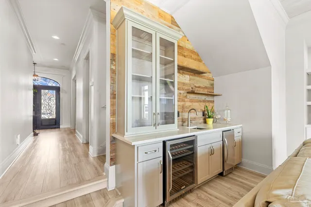 a view of a dining room with furniture a chandelier and wooden floor