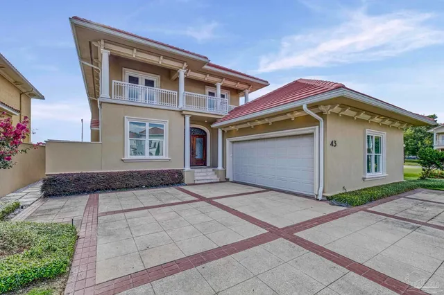 a front view of a house with a yard table and chairs