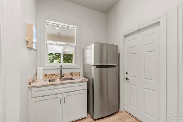a large spacious bathroom with a double vanity sink a mirror and a bathtub