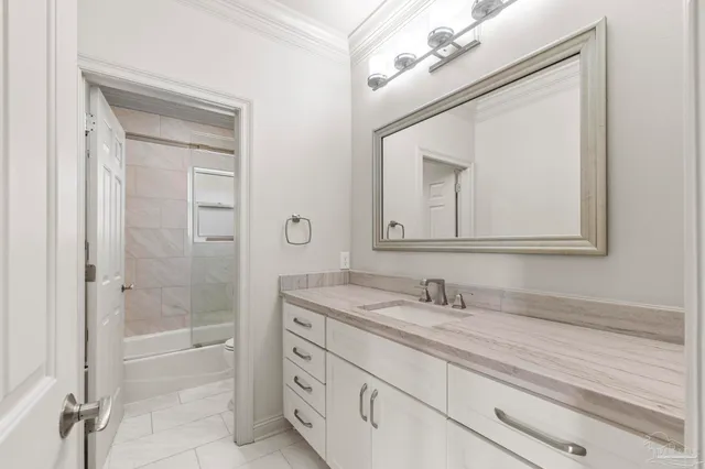 an aerial view of a house with a garden and lake view