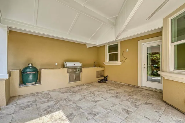 an aerial view of a house with swimming pool and ocean view