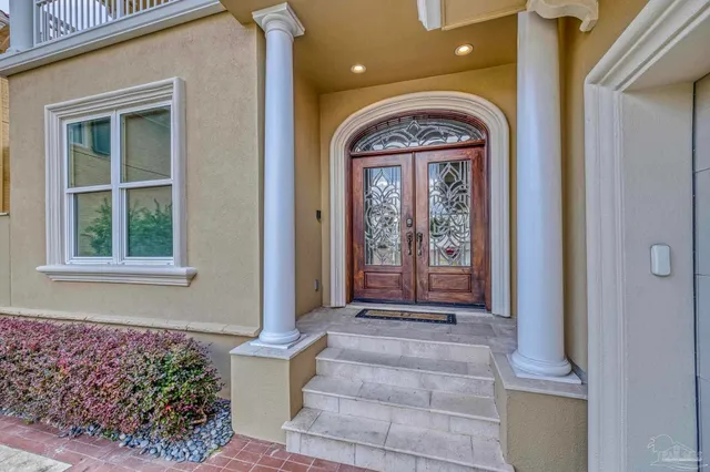 a view of a hallway with wooden floor and entryway