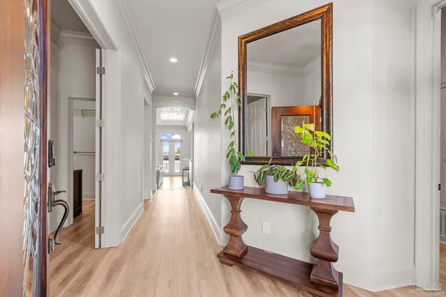 a living room with furniture and a large window with garden view