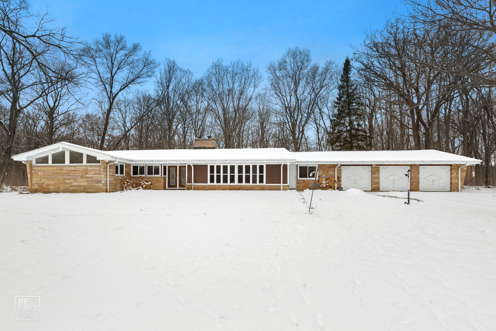 23670 North Elm Road Lincolnshire, IL 60069 - Photo 1 of 36 a view of a white house with a big yard and large trees