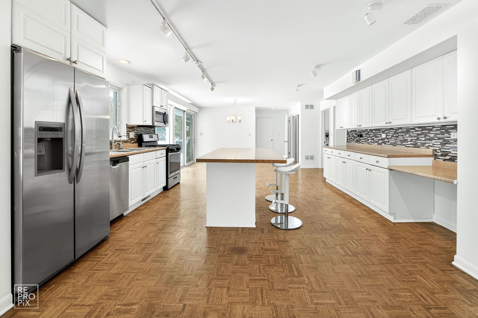 23670 North Elm Road Lincolnshire, IL 60069 - Photo 11 of 36 a kitchen with stainless steel appliances granite countertop a refrigerator a stove and a sink