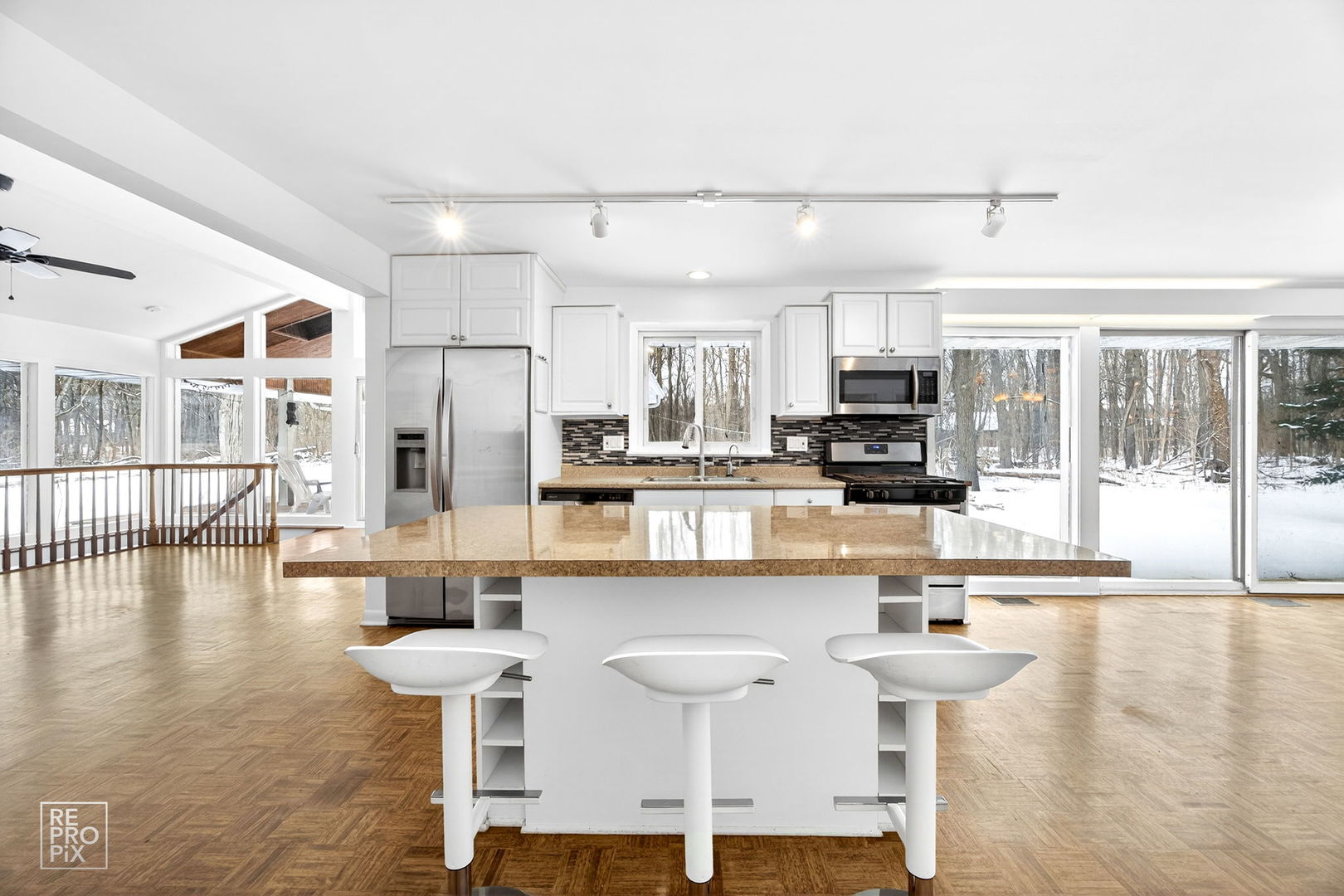 23670 North Elm Road Lincolnshire, IL 60069 - Photo 12 of 36 a kitchen with stainless steel appliances a dining table chairs and a wooden floor