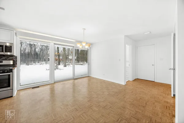 a view of empty room with floor to ceiling window