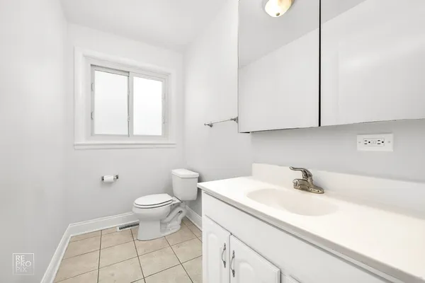 a bathroom with a sink toilet and vanity