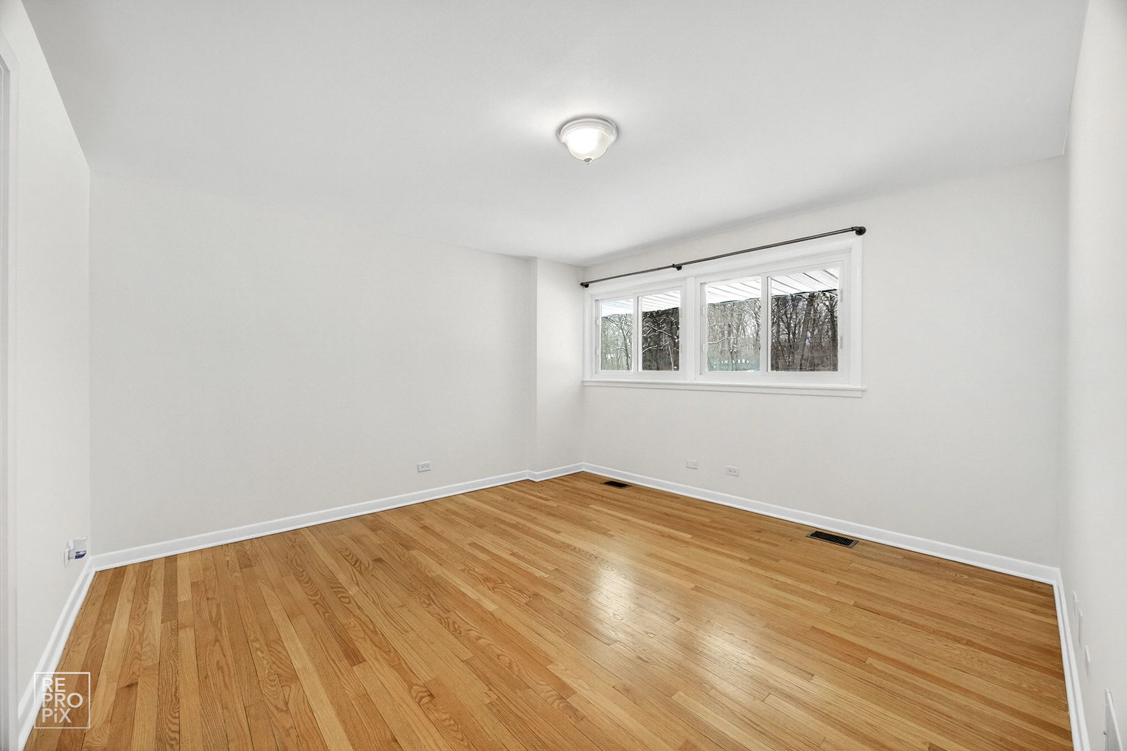 23670 North Elm Road Lincolnshire, IL 60069 - Photo 20 of 36 a view of empty room with wooden floor and fan