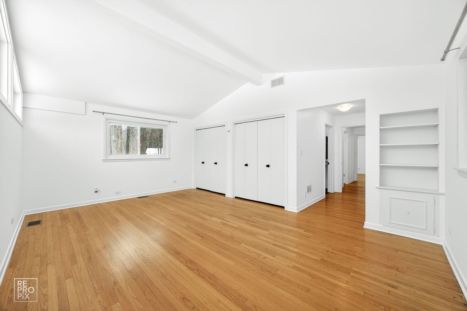 23670 North Elm Road Lincolnshire, IL 60069 - Photo 22 of 36 a view of an empty room with a window and wooden floor