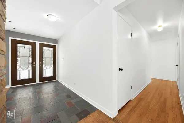 a view of an entryway with wooden floor