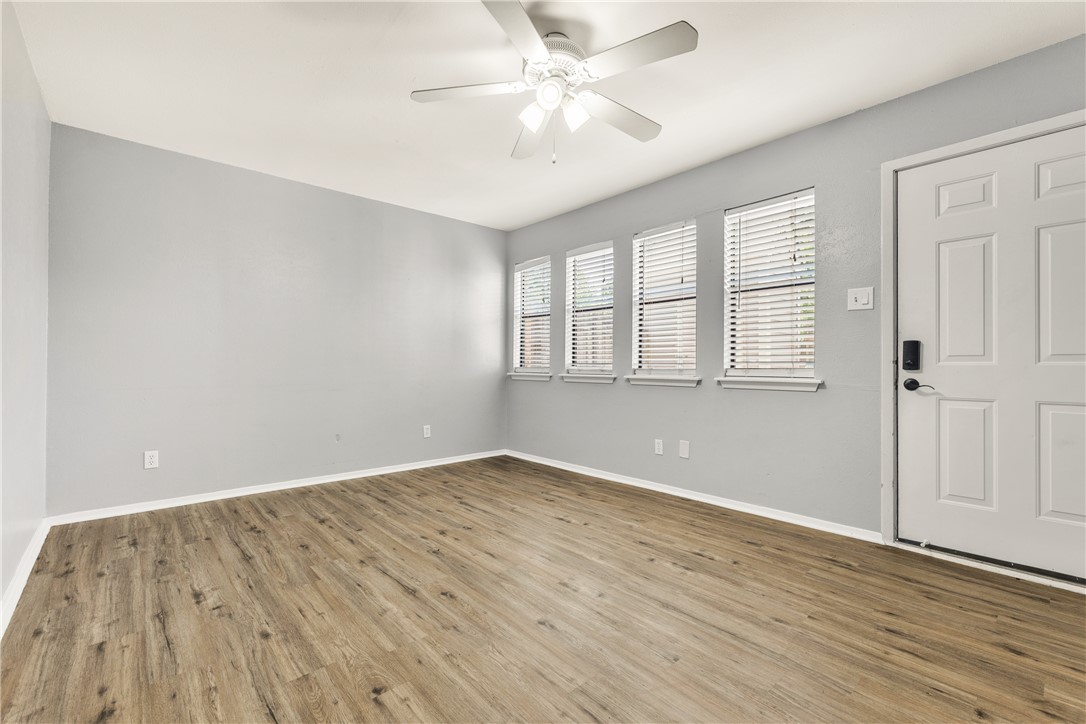2101 Barak Lane, Unit 17 Bryan, TX 77802 - Photo 4 of 19 wooden floor in an empty room with a window
