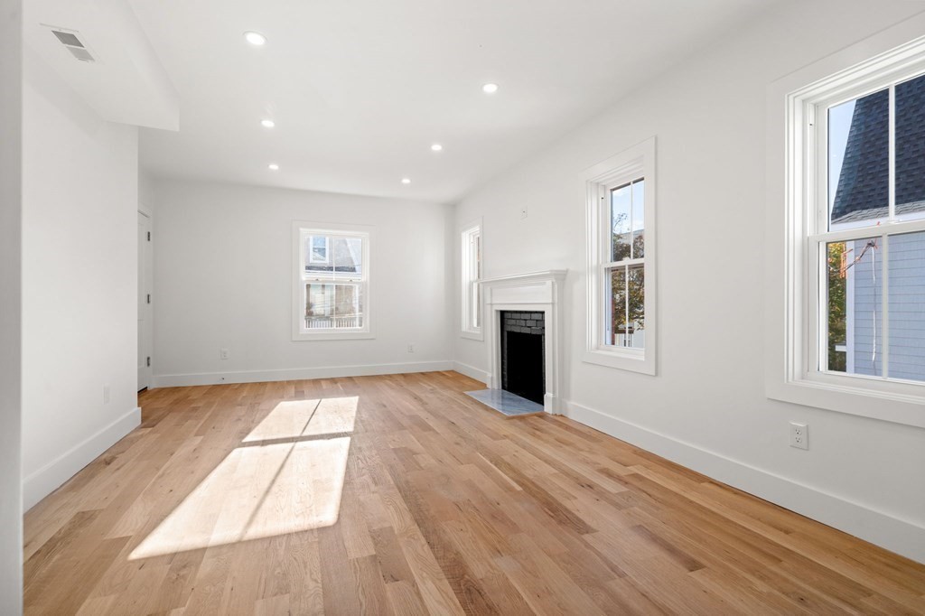 111 Leach Street, Unit 1 Salem, MA 01970 - Photo 11 of 32 a view of an empty room with a window and fireplace