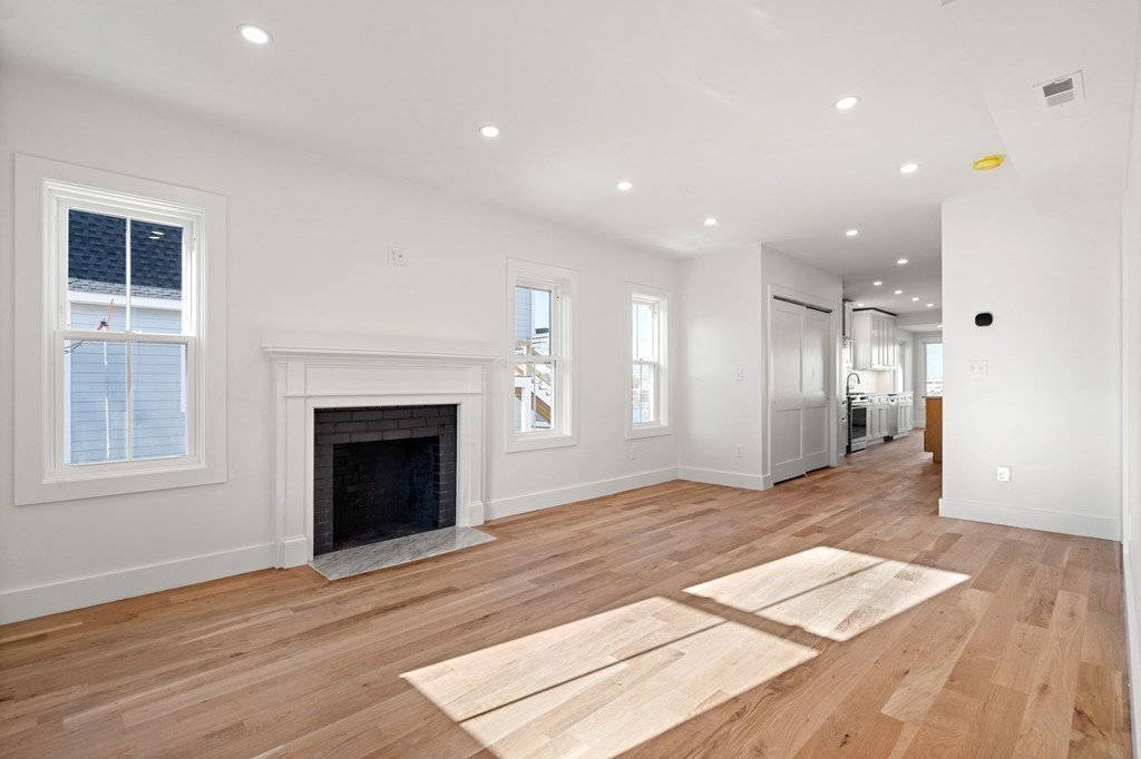 111 Leach Street, Unit 1 Salem, MA 01970 - Photo 13 of 32 a view of livingroom with hardwood floor and a fireplace
