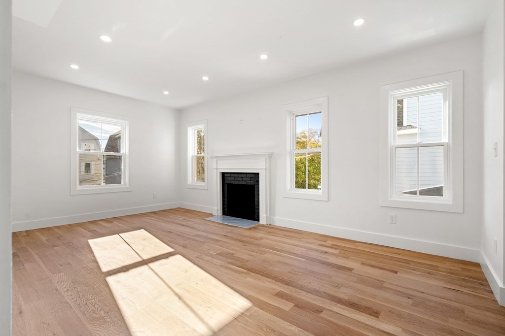 111 Leach Street, Unit 1 Salem, MA 01970 - Photo 15 of 32 an empty room with windows and fireplace