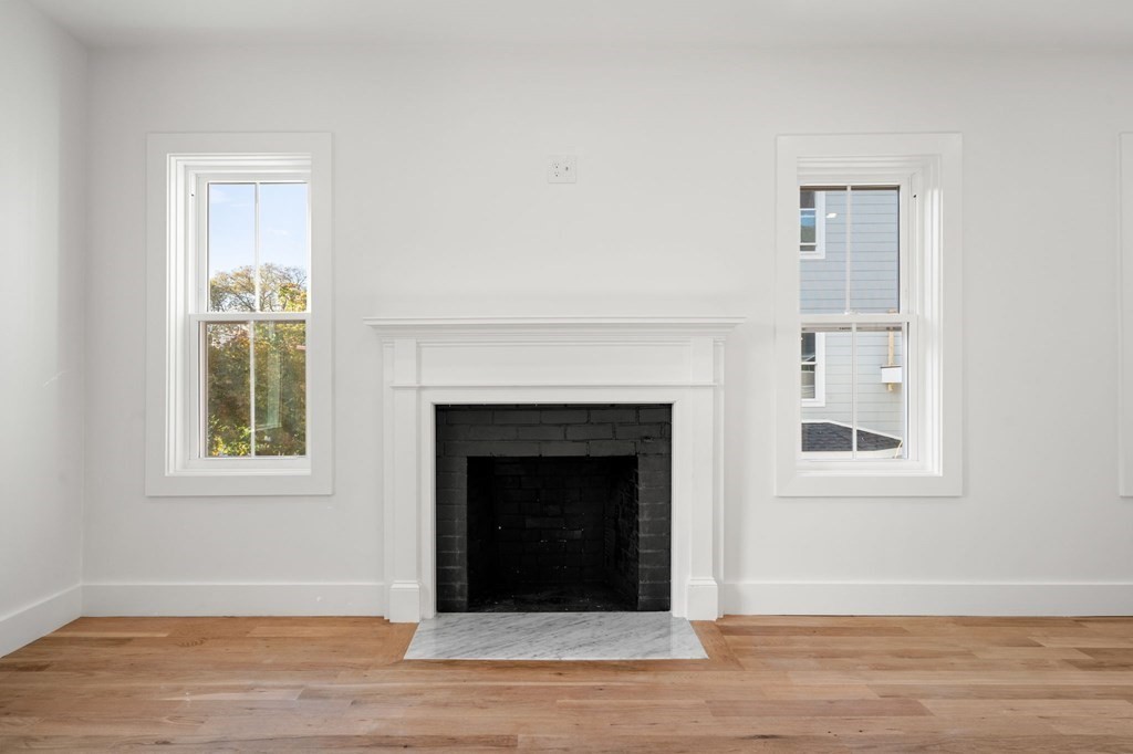 111 Leach Street, Unit 1 Salem, MA 01970 - Photo 16 of 32 a view of an empty room with wooden floor and a window