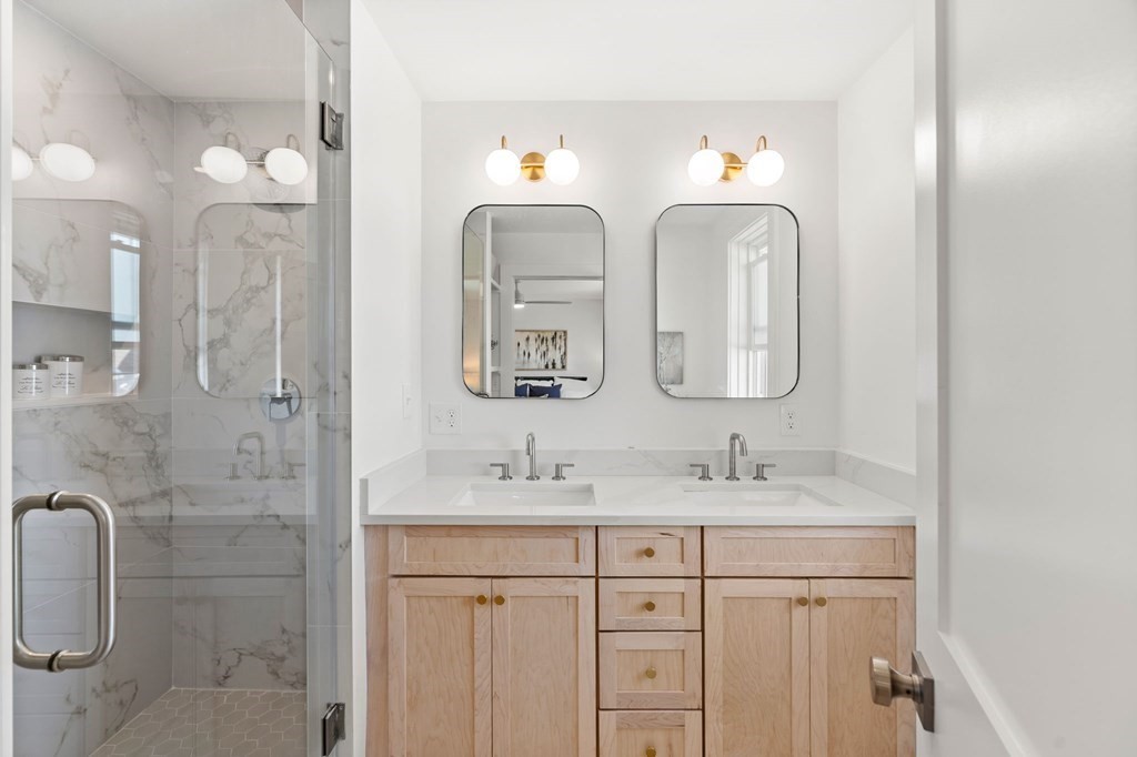 111 Leach Street, Unit 1 Salem, MA 01970 - Photo 17 of 32 a bathroom with double vanity sinks and a shower
