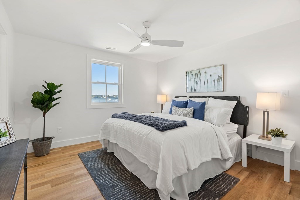 111 Leach Street, Unit 1 Salem, MA 01970 - Photo 24 of 32 a bedroom with bed and a potted plant
