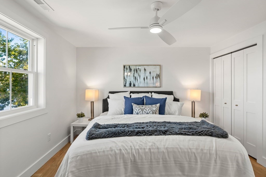 111 Leach Street, Unit 1 Salem, MA 01970 - Photo 25 of 32 a bedroom with a large bed and a chandelier