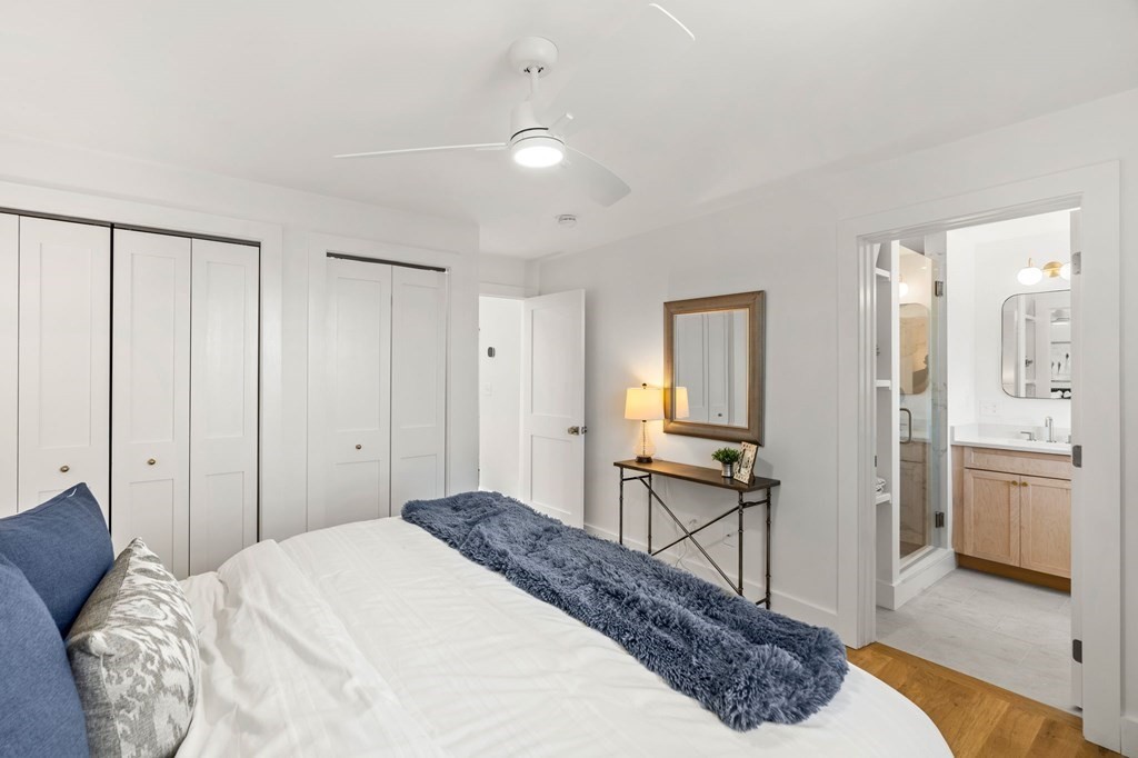 111 Leach Street, Unit 1 Salem, MA 01970 - Photo 26 of 32 a spacious bedroom with a bed and wooden floor