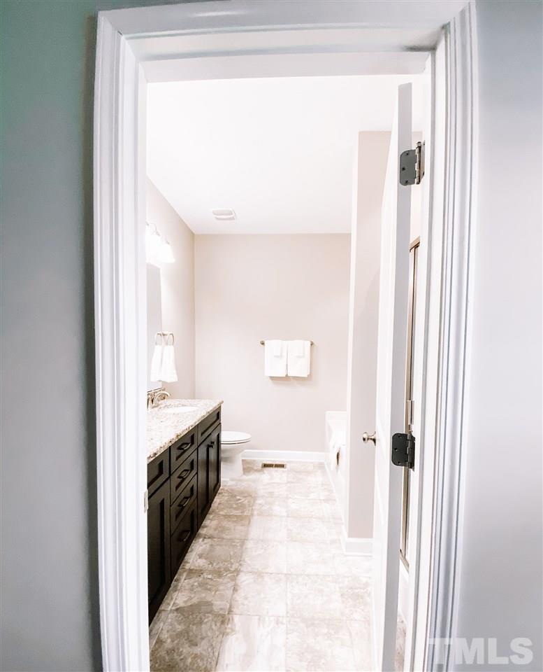 7989 Creech Road Middlesex, NC 27557 - Photo 11 of 20 a bathroom with a double vanity sink and a mirror