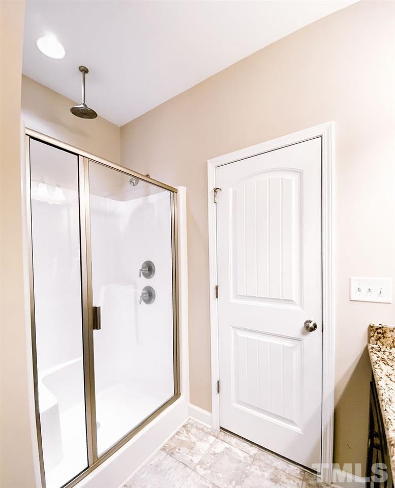 7989 Creech Road Middlesex, NC 27557 - Photo 13 of 20 a bathroom with a glass shower door