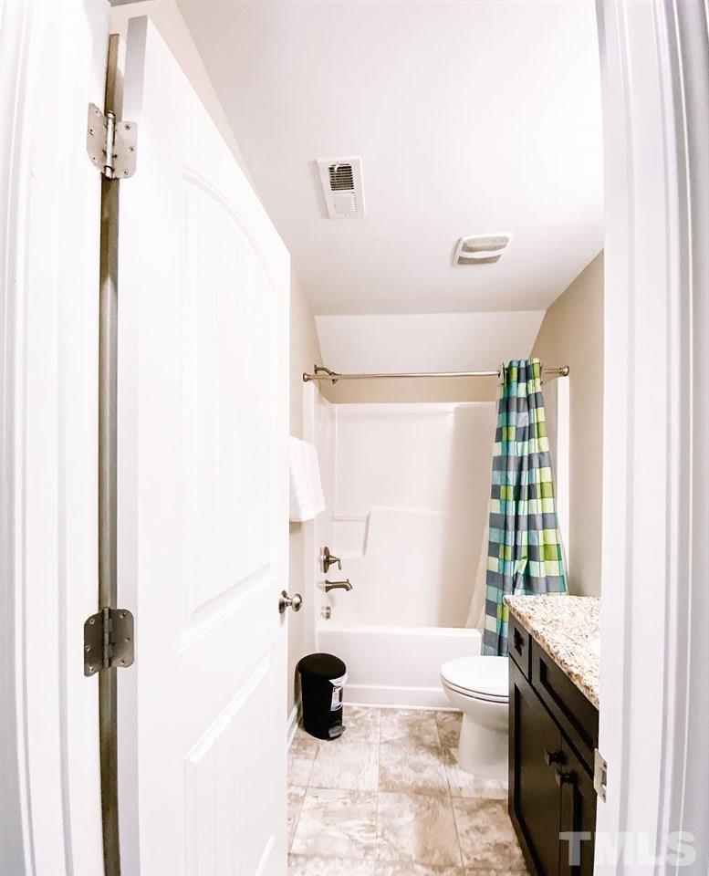 7989 Creech Road Middlesex, NC 27557 - Photo 17 of 20 a bathroom with a tub sink and mirror