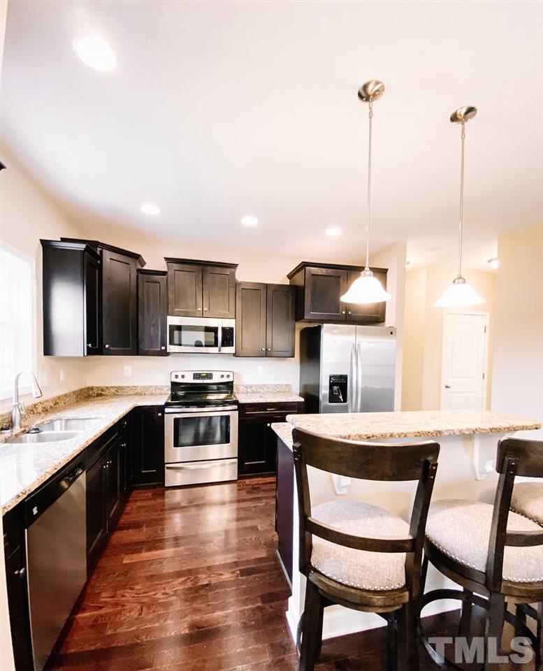 7989 Creech Road Middlesex, NC 27557 - Photo 4 of 20 a kitchen with a table chairs sink and cabinets