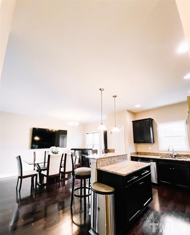 7989 Creech Road Middlesex, NC 27557 - Photo 5 of 20 a kitchen with a table chairs and a stove