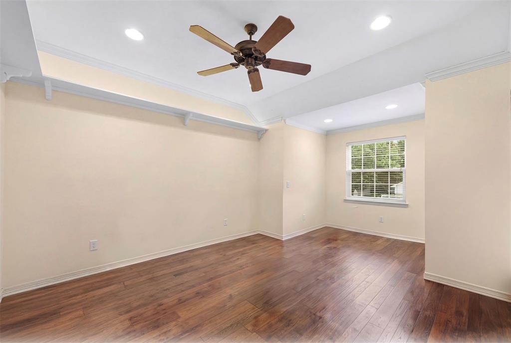 506 Meadowview Road Heath, TX 75032 - Photo 23 of 32 a view of an empty room with wooden floor and a window
