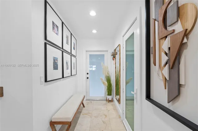 a view of an entryway with wooden floor and a livingroom