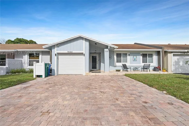 a front view of a house with a yard and table and chairs