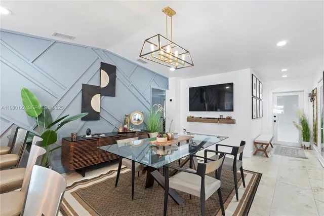 a view of a livingroom with furniture and a flat screen tv