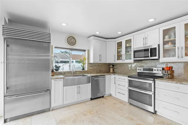 a kitchen with stainless steel appliances granite countertop a stove and a sink