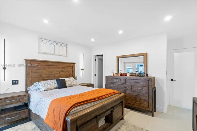 a bedroom with a bed and a dresser