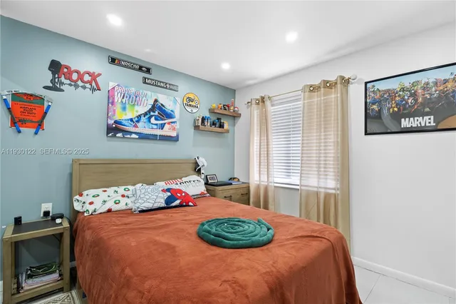 a bedroom with a bed and wall painting on the wall