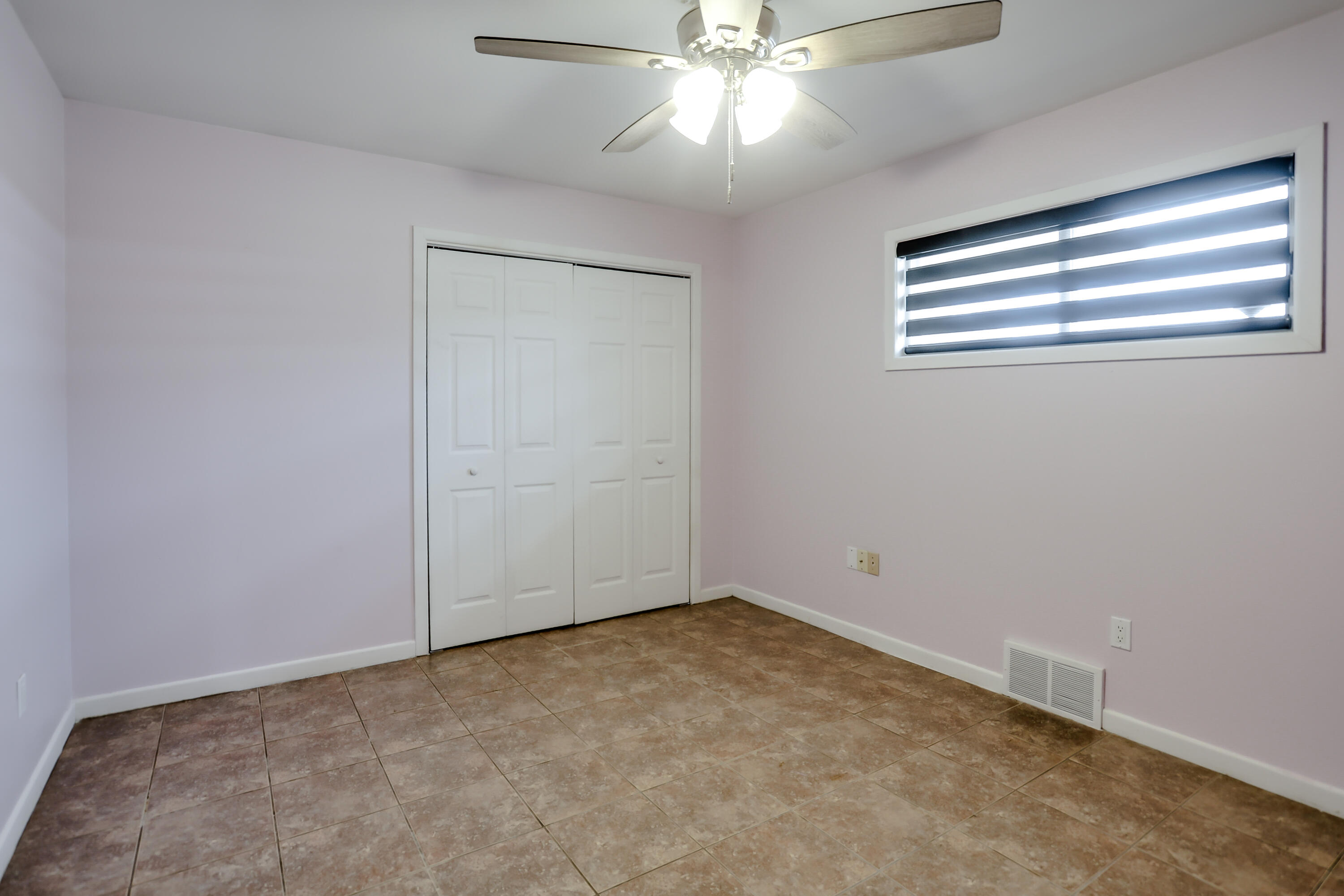 3615 47th Street Lubbock, TX 79413 - Photo 25 of 36 an empty room with a window and a fan