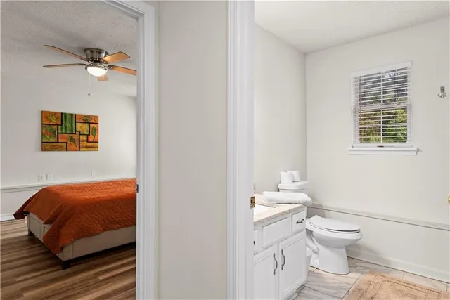 a bathroom with a toilet a sink and a mirror