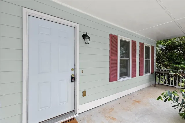 a view of front door and porch with seating space