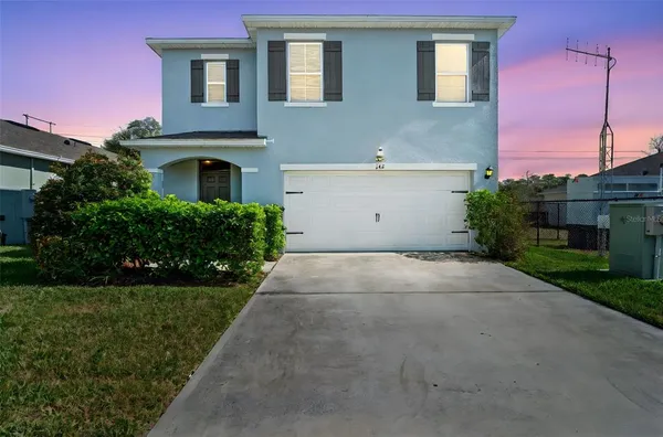 a front view of a house with a yard and garage