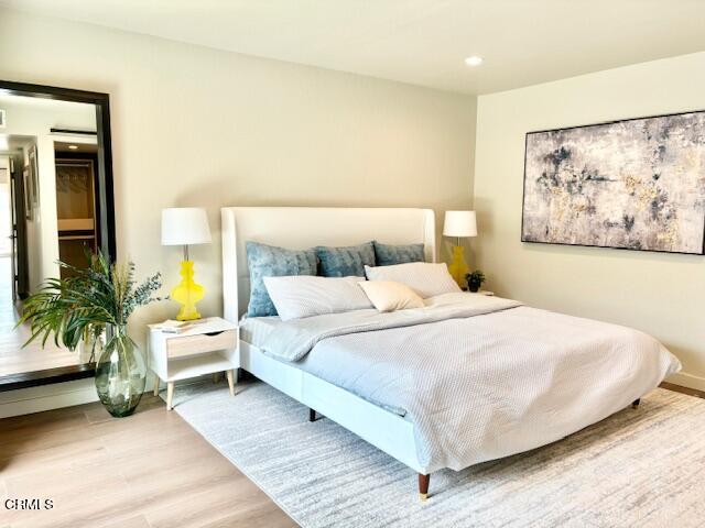 4510 Gateshead Bay Oxnard, CA 93035 - Photo 19 of 34 a bedroom with a bed lamp and paintings on the wall