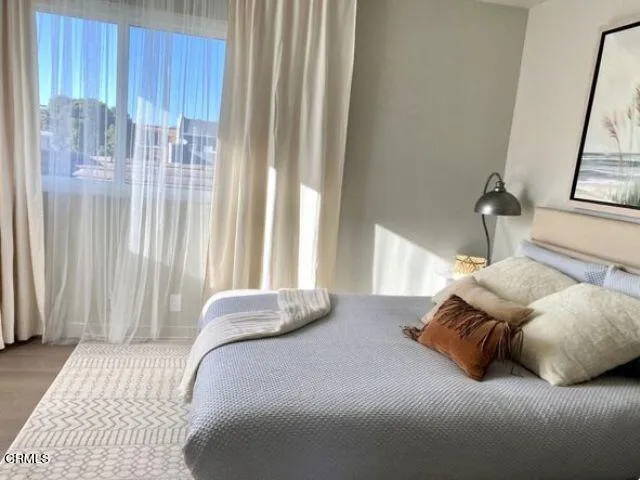 a bedroom with a bed and window