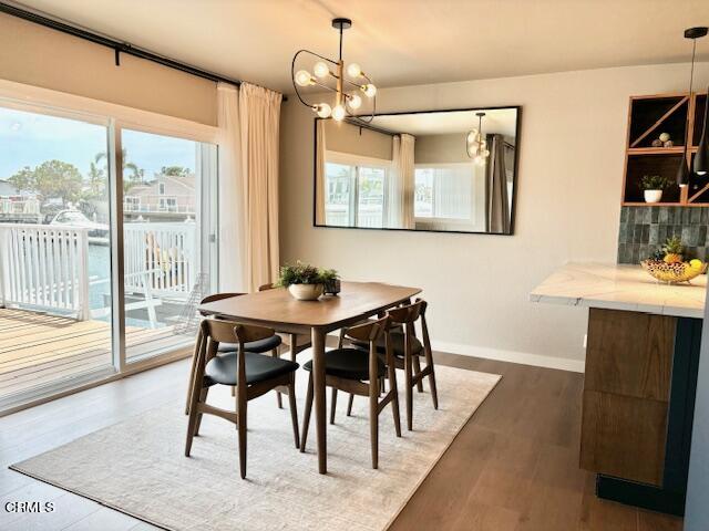 4510 Gateshead Bay Oxnard, CA 93035 - Photo 8 of 34 a view of a dining room with furniture window and wooden floor