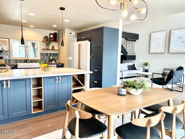 4510 Gateshead Bay Oxnard, CA 93035 - Photo 9 of 34 a kitchen with a dining table chairs and refrigerator