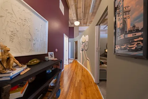 a hallway with a stove and a wooden floor