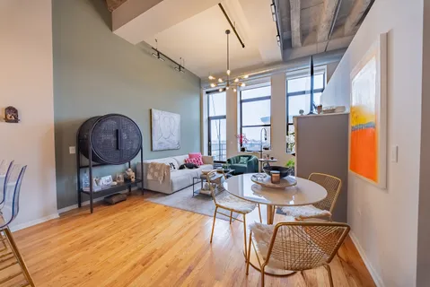 a living room with furniture a window and a chandelier