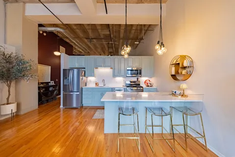 a view of a kitchen with a table and chairs